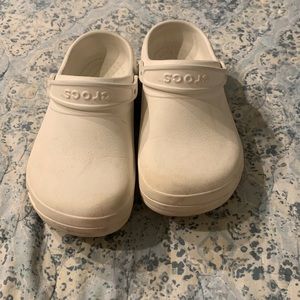 Croc’s all white closed toed clogs.